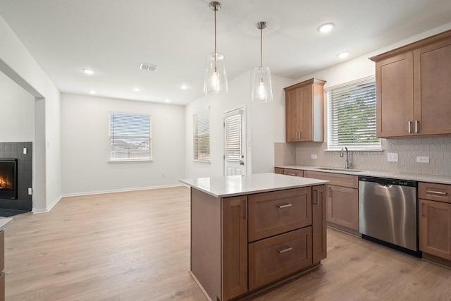 13228 Ditka Dr, Austin, TX 78652 - kitchen featuring dishwasher, a sink, light wood-style flooring, light countertops, and recessed lighting