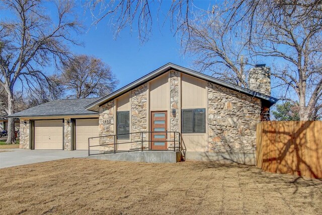 contemporary home featuring a garage and a front lawn