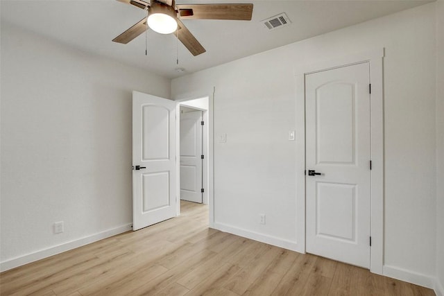 unfurnished bedroom with light wood finished floors, visible vents, and baseboards