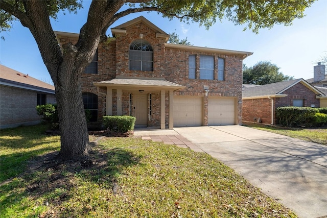 view of front property featuring a garage and a front yard