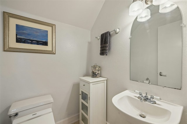 bathroom featuring vaulted ceiling, sink, and toilet