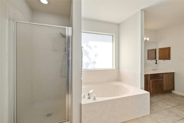 bathroom featuring tile patterned flooring, vanity, and separate shower and tub