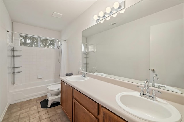 full bathroom with vanity, tile patterned floors, toilet, and tiled shower / bath