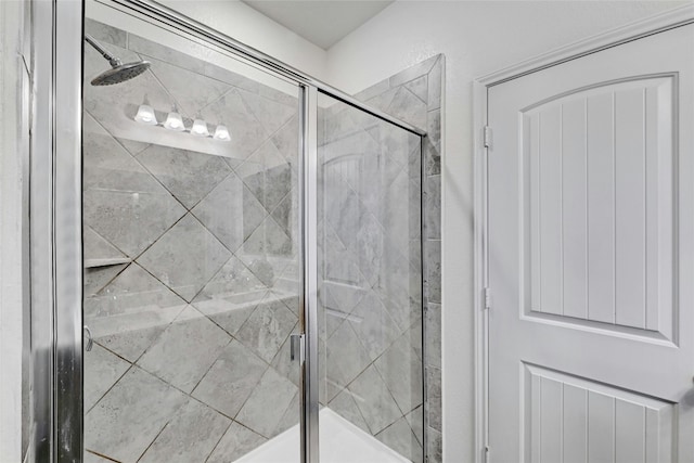 bathroom with a shower with shower door