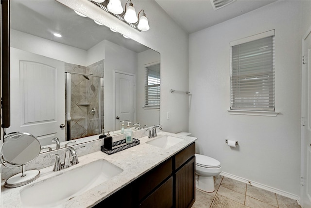 bathroom featuring vanity, toilet, tile patterned flooring, and a shower with door