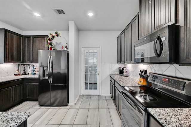 17011 Prestons Braid Ln, Round Rock, TX 78664 - kitchen featuring appliances with stainless steel finishes, tasteful backsplash, light stone counters, dark brown cabinetry, and recessed lighting