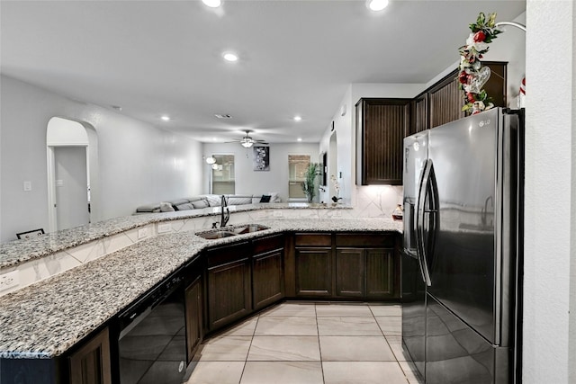 17011 Prestons Braid Ln, Round Rock, TX 78664 - kitchen featuring stainless steel fridge, a sink, black dishwasher, ceiling fan, and light stone counters