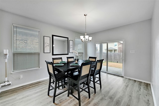 dining room with a notable chandelier and light hardwood / wood-style floors