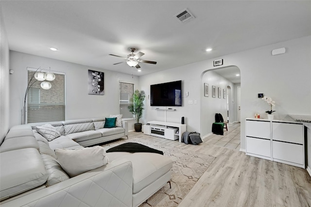 living room with ceiling fan and light hardwood / wood-style floors