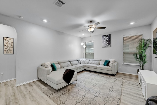 living room with ceiling fan and light hardwood / wood-style floors