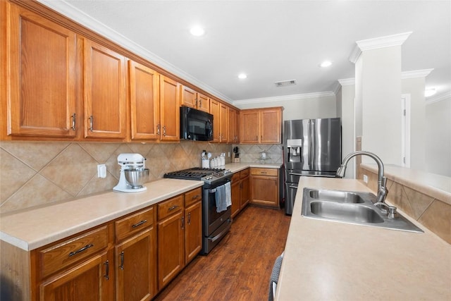 kitchen with dark hardwood / wood-style floors, tasteful backsplash, sink, ornamental molding, and stainless steel appliances