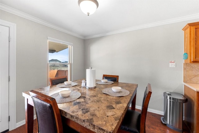 dining room featuring crown molding and dark wood-type flooring