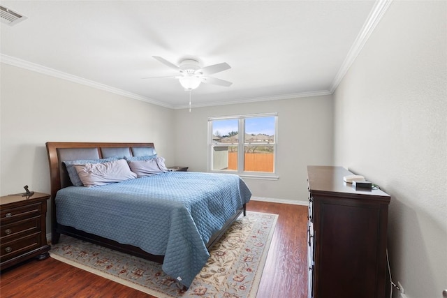 bedroom with dark wood-type flooring, ceiling fan, and ornamental molding