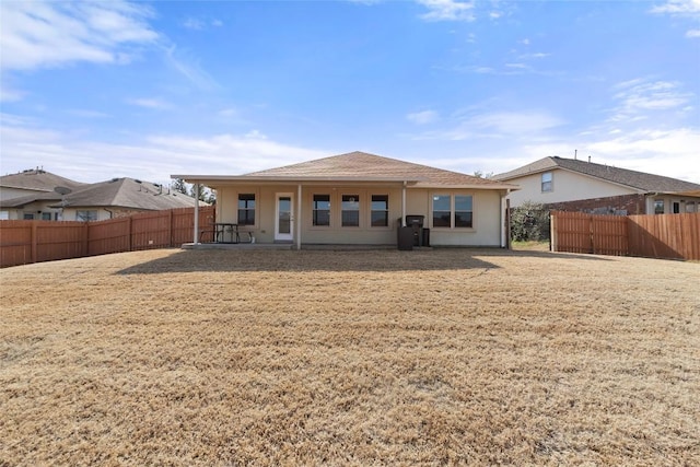 back of property featuring a lawn