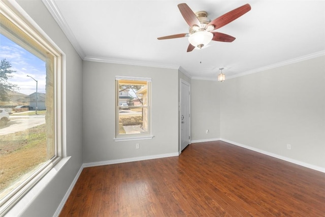 empty room featuring dark hardwood / wood-style flooring, crown molding, and ceiling fan