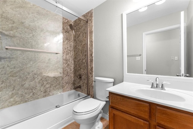 full bathroom with vanity, shower / bath combination with glass door, and toilet