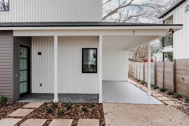 property entrance with a carport