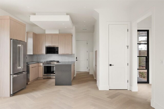 kitchen featuring stainless steel appliances, tasteful backsplash, light brown cabinets, a kitchen island, and light parquet flooring