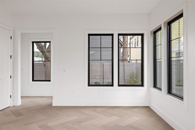 empty room with light parquet flooring