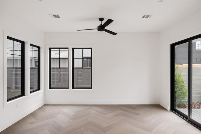 unfurnished room with light parquet floors and ceiling fan