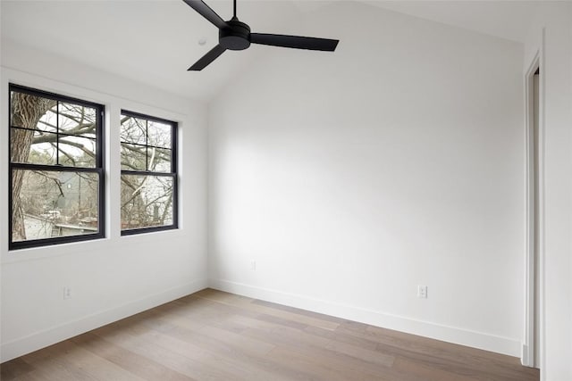 spare room with ceiling fan, lofted ceiling, and light hardwood / wood-style floors