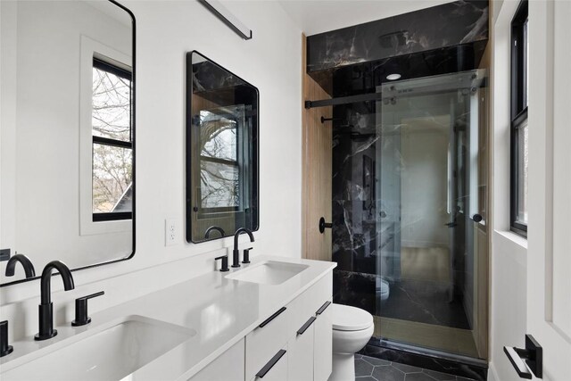 bathroom with vanity, tile patterned flooring, toilet, and walk in shower