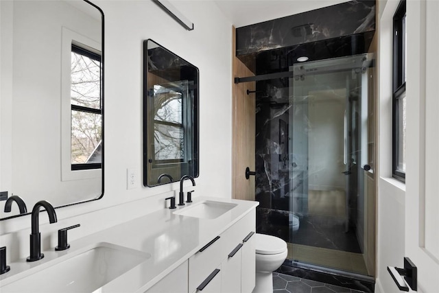 bathroom with tile patterned flooring, vanity, toilet, and walk in shower