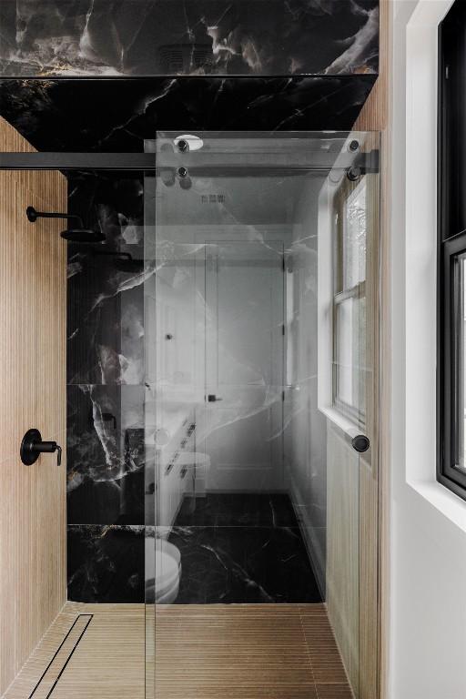 bathroom with a shower with door