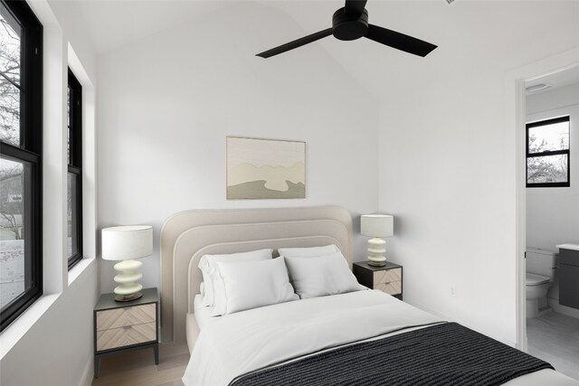 bedroom featuring vaulted ceiling, connected bathroom, ceiling fan, and light hardwood / wood-style floors