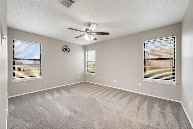 carpeted empty room with a textured ceiling and ceiling fan