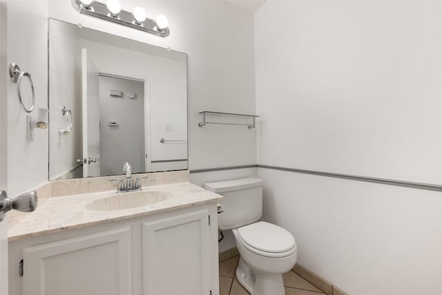 bathroom with tile patterned floors, vanity, and toilet