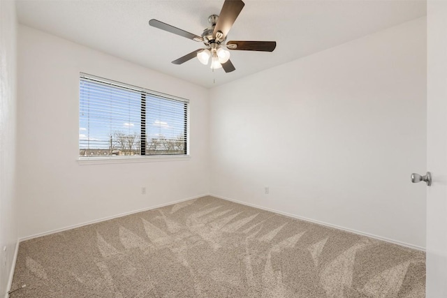 carpeted spare room with ceiling fan