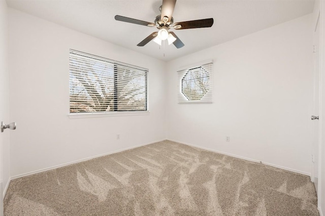 carpeted spare room with ceiling fan