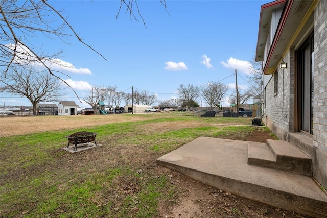 view of yard with an outdoor fire pit