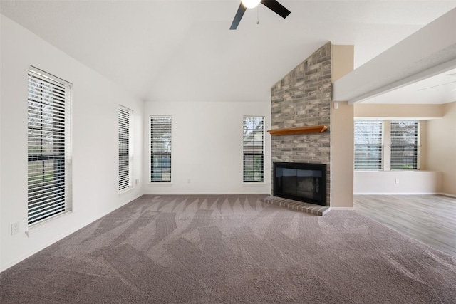 unfurnished living room featuring ceiling fan, carpet, high vaulted ceiling, and a fireplace