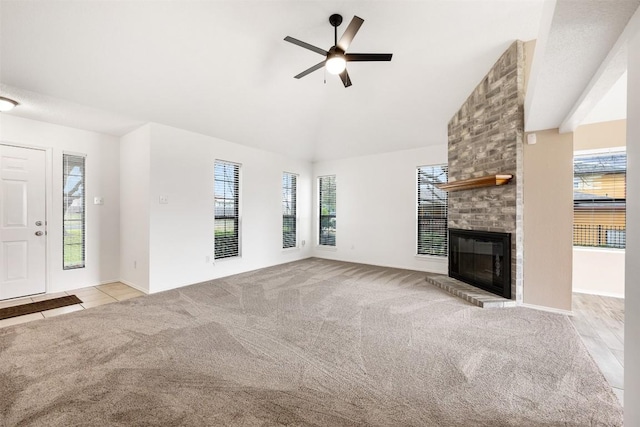 unfurnished living room featuring a brick fireplace, light colored carpet, lofted ceiling, and ceiling fan