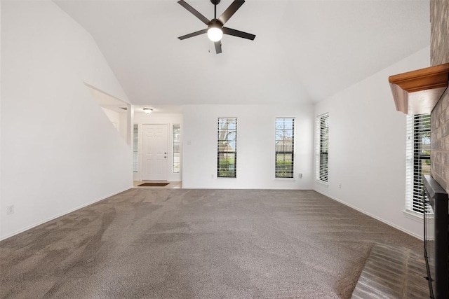 unfurnished living room with ceiling fan, carpet, and high vaulted ceiling