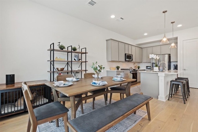 dining room featuring light wood-type flooring, visible vents, and recessed lighting