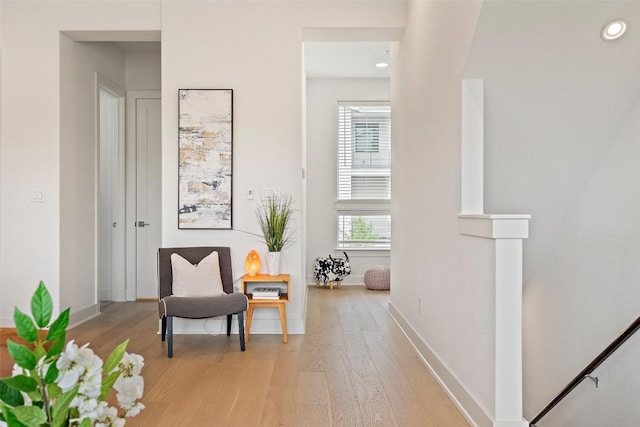 sitting room with recessed lighting, baseboards, and light wood finished floors