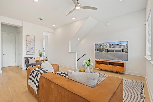 living room featuring ceiling fan and light hardwood / wood-style flooring