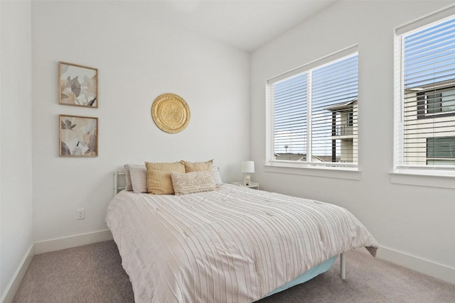 carpeted bedroom featuring baseboards