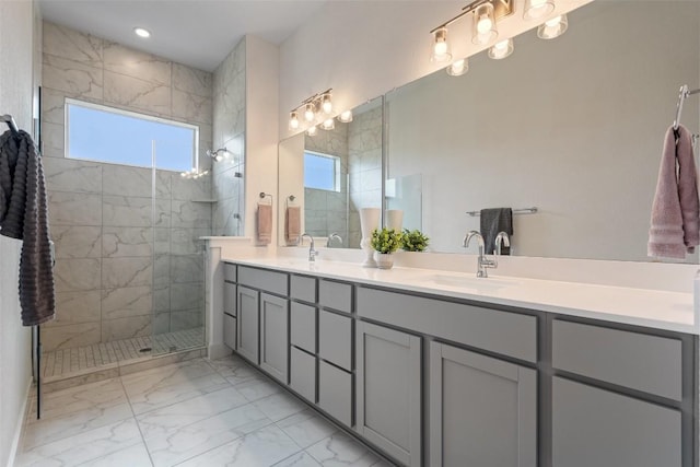 full bathroom featuring double vanity, marble finish floor, a walk in shower, a sink, and recessed lighting