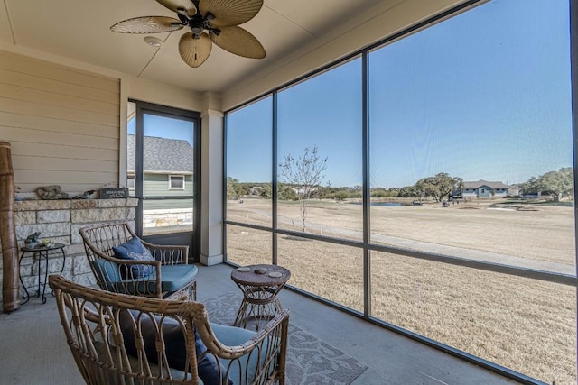 sunroom featuring ceiling fan