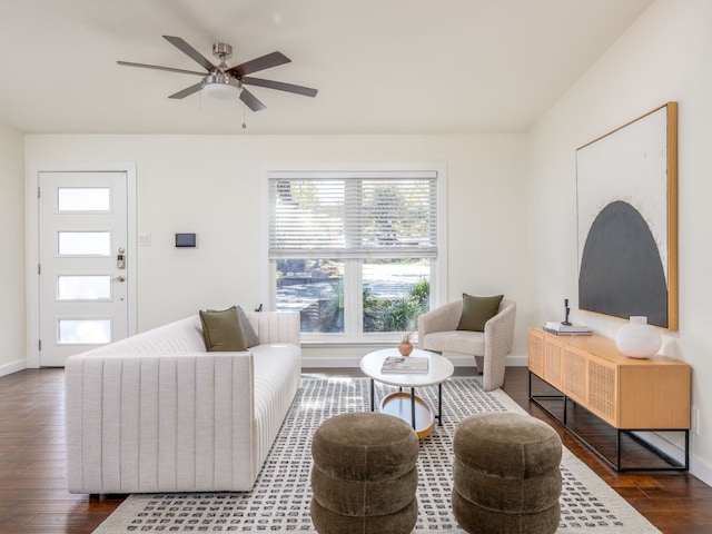 living room with ceiling fan and dark hardwood / wood-style flooring