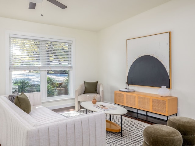 living room featuring hardwood / wood-style floors and ceiling fan