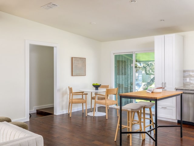 dining area with dark hardwood / wood-style floors