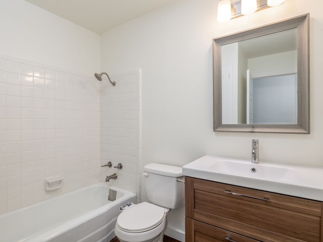 full bathroom with tiled shower / bath combo, vanity, and toilet