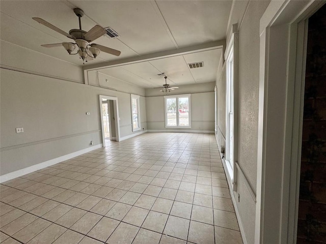 tiled spare room with ceiling fan