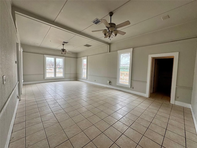 tiled empty room featuring ceiling fan