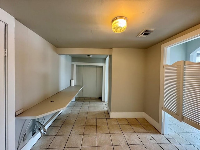 corridor with light tile patterned flooring